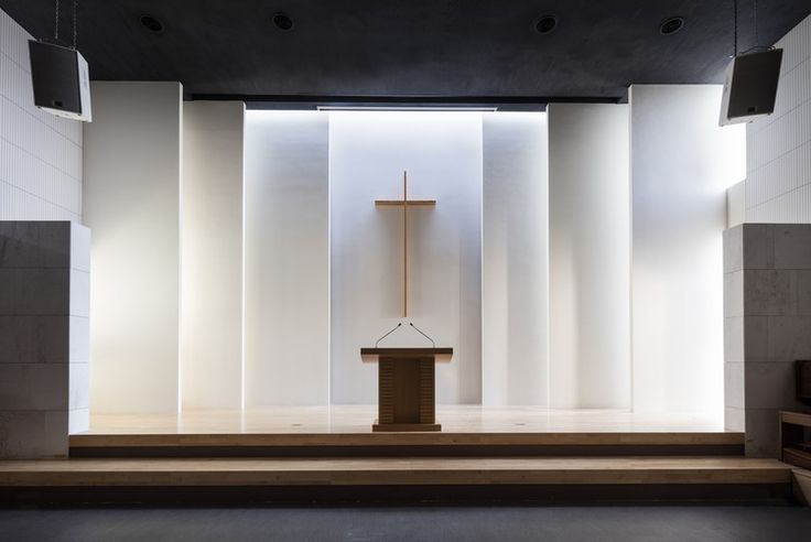 an empty church with a cross on the alter