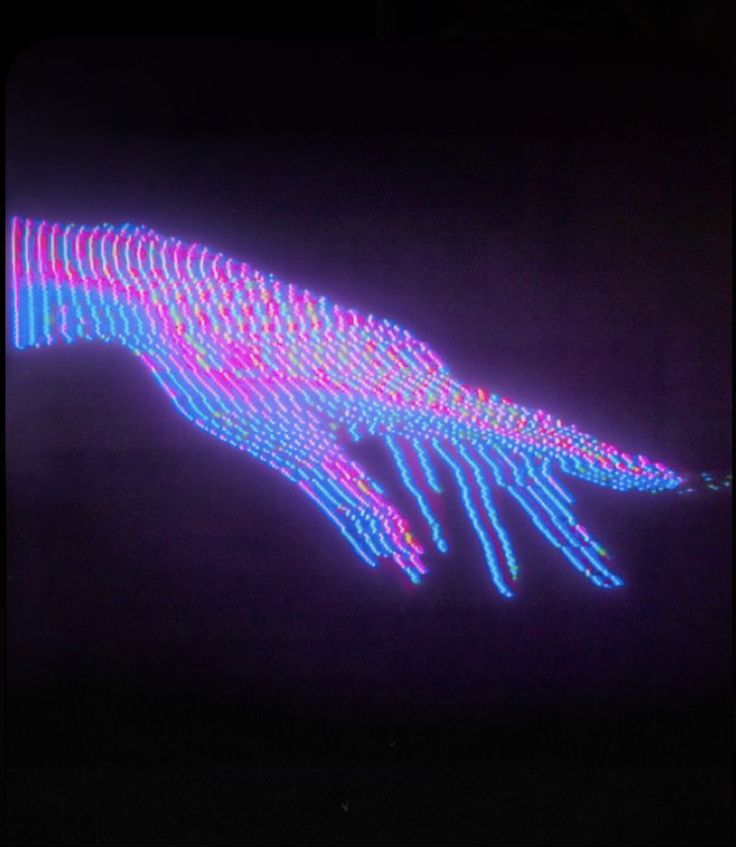 an image of a hand that is lit up in the dark with neon lights on it