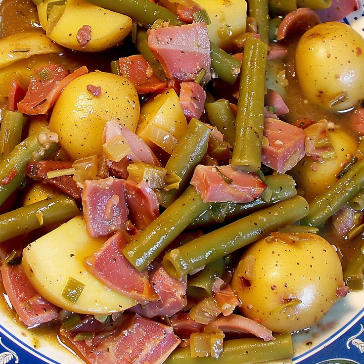 a plate full of potatoes, green beans and ham