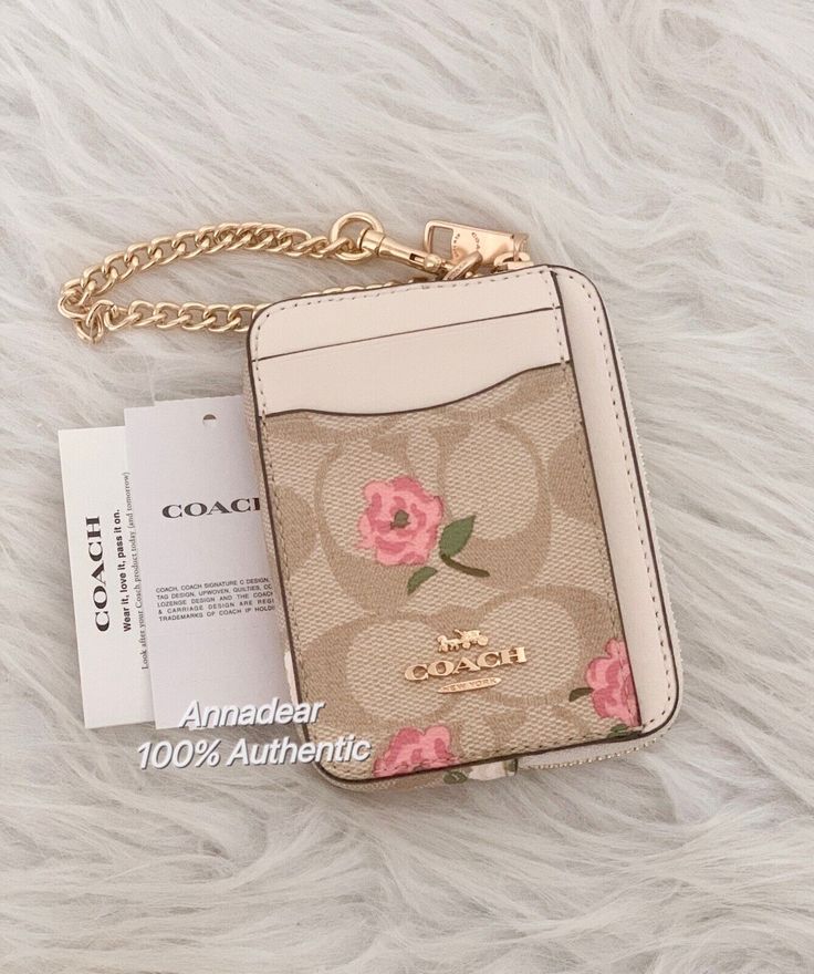 Coach Zip Card Case In Signature Canvas With Floral Print Limited Edition 100% Authentic Color: Gold/Light Khaki Chalk Multi Product Details Signature coated canvas and smooth leather Two credit card slots ID window Open pockets Zip compartment Chain wrist strap with dogleash clip attached 3" (L) x 4 1/4" (H) x 3/4" (W) Style No. CR971 Cute Purses Designer, Shop Products, Coach Clothes, Pink Stuff To Buy, Pink Coach Bags, Stuff I Want To Buy, Coach Card Holder, Designer Items, Coach Purses Aesthetic