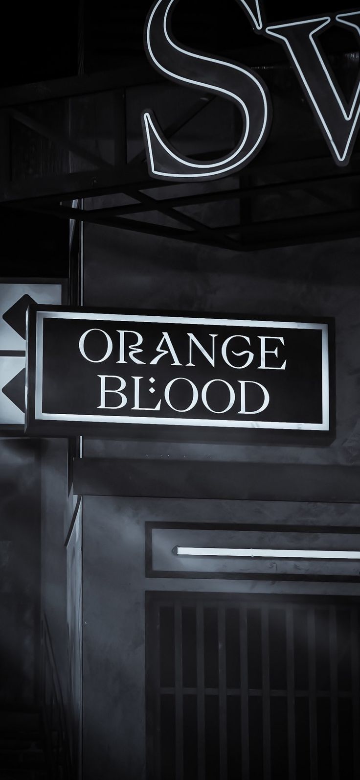 an orange blood sign hanging from the side of a building