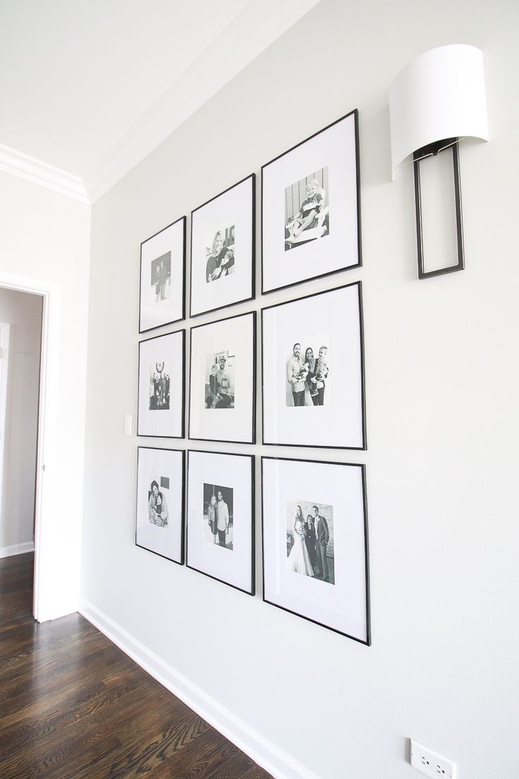 a white wall with black and white pictures on it