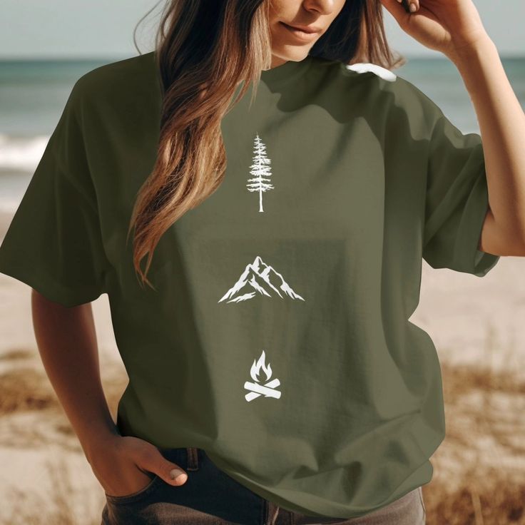 Express your love of #camping, #thegreatoutdoors, #epicadventures, #mountainviews and a good #campfire with this simple iconic design. https://dirtandsoul.etsy.com/listing/1728785036 #outdoorstyle #tshirt #outdoorapparel #gooutside Hiking Tshirt Design Ideas, Camping Tshirt Design, Outdoor T Shirt Design, Adventure Tshirt Design, Camping Tshirt Ideas, Outdoor Graphic Design, Camp Tshirt Designs, Tree Mountain, Kaos Oblong