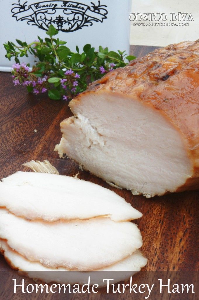 a close up of sliced meat on a wooden table