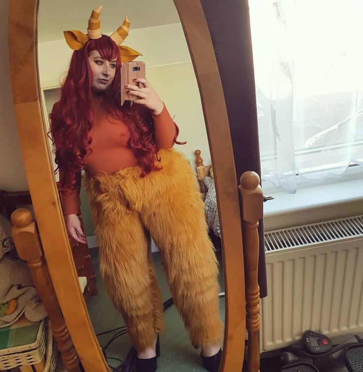 a woman is taking a selfie in front of a mirror wearing an animal costume