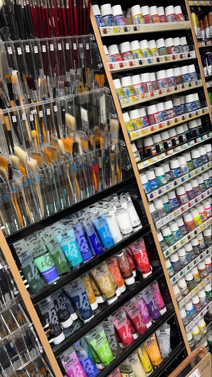 the shelves are filled with different types of paint and brushes for sale in a store