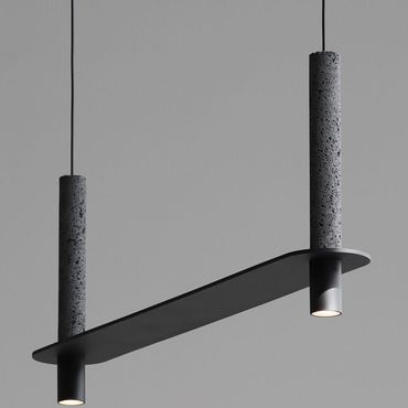 three lights hanging from the ceiling in an empty room with grey walls and flooring