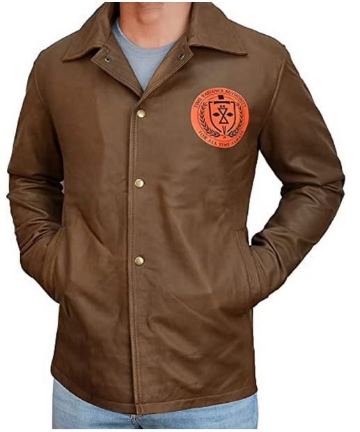 a man wearing a brown jacket with an orange emblem