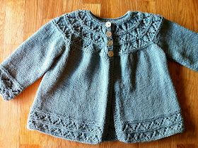 a blue sweater sitting on top of a wooden floor