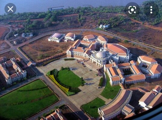 an aerial view of a large building in the middle of a field