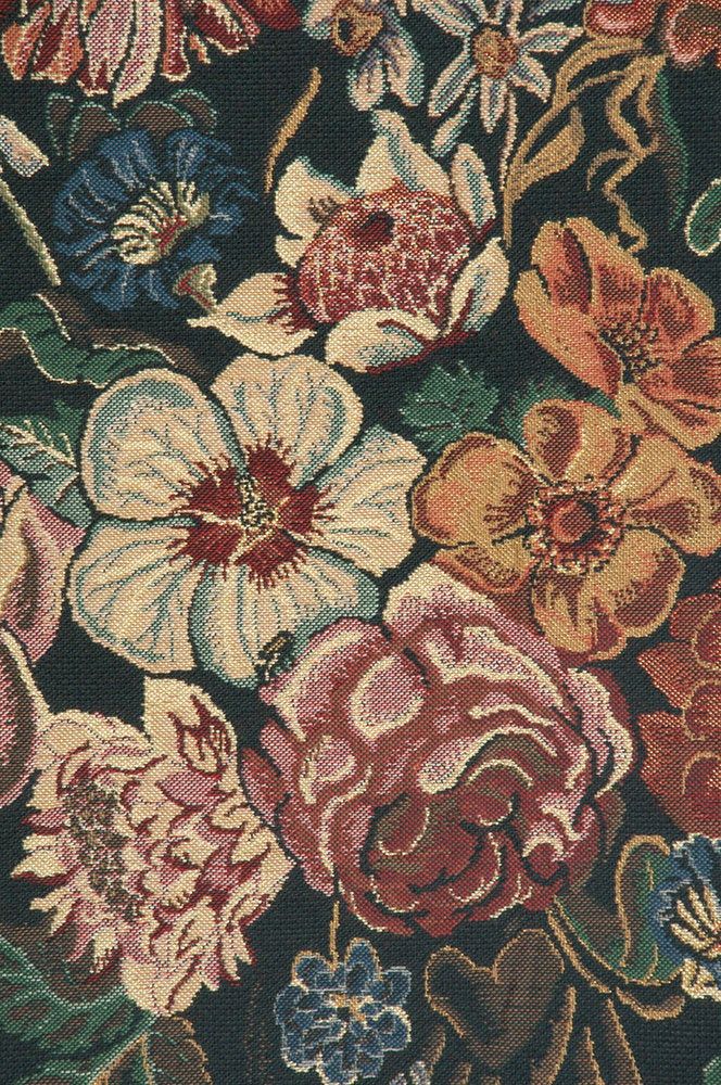 a bunch of flowers that are on top of a table cloth, with one flower in the middle