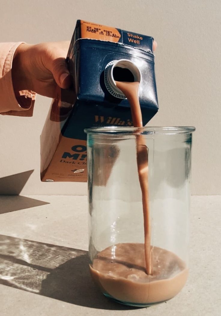 person pouring chocolate oat milk into a glass Coffee With Oat Milk, Milk Photoshoot, Chocolate Oat Milk, Milk Brands, Dairy Free Alternatives, Artificial Food, Chocolate Oats, Food Additives, Coffee Milk