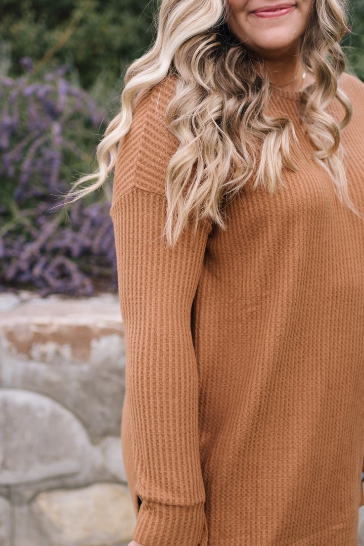 cozy up to this brushed thermal waffle knit. it has long fitted sleeves and then the rest is loose and flowy, just how we like it. split high low hem. it is so soft and long enough to throw on with your favorite pair of leggings. riley is 5'8" and wearing a 1XL. fits true to size for an oversized fit. 1XL measurements: 31.5" length, 53" bust. Winter Long Sleeve Top With Thumbholes For Loungewear, Cozy Waffle Knit Sweater For Loungewear, Everyday Waffle Knit Long Sleeve Sweater, Everyday Long Sleeve Waffle Knit Sweater, Long Sleeve Winter Loungewear Top, Long Sleeve Waffle Knit Sweater For Fall, Fall Waffle Knit Long Sleeve Sweater, Textured Knit Tops For Fall Loungewear, Waffle Knit Long Sleeve Sweater For Fall