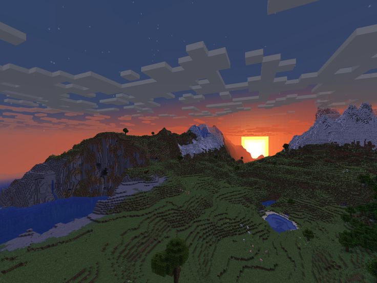 the sun is setting over some mountains with trees and bushes in front of an orange sky