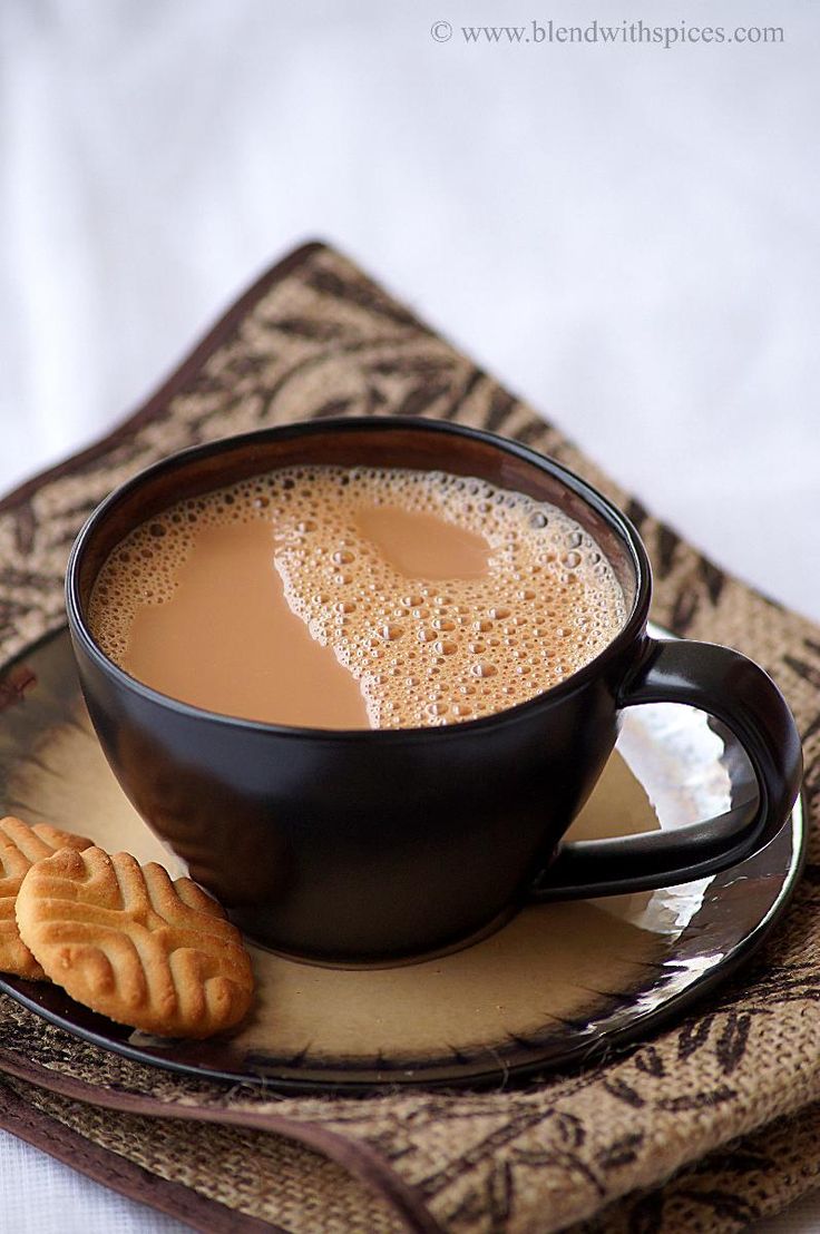 a cup of coffee and some crackers on a plate with an instagram post