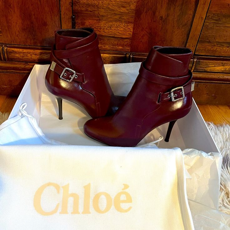 New Unworn Leather Chloe Booties. They Are A Rich Burgundy/Purple Color In Size 38.5 With A Heel Height Of Approximately 3.5 Inches And An Ankle Circumference Of Approximately 9 Inches. Very Chic And Stylish!!! They Will Be Shipped In The Original Shoe Box With The Original Shoe Dust Bag. Chic Ankle Strap Boots, Elegant Leather Booties With Ankle Strap, Elegant Leather Ankle Strap Booties, Chic Burgundy Heeled Boots With Round Toe, Chic Boots With Heel Strap And Round Toe, Chic Ankle Strap Boots With Padded Heel, Chic Ankle Strap Booties Medium Width, Chic Burgundy Boots With Reinforced Heel, Chic Purple Pointed Toe Boots