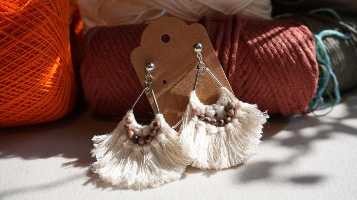 Boho Chic White Beaded Earrings  Embrace the free-spirited vibe with these bohemian white and brown beaded earrings. The contrasting colors and intricate designs create a unique and eye-catching look. Perfect for adding a touch of boho flair to any outfit. **Features * Handmade with care * Lightweight and comfortable * Made with high-quality beads * Bohemian white with brown beaded design **Care * Gently wipe clean with a soft cloth * Avoid submersion in water **Note Due to the handmade nature of these earrings, there may be slight variations in size and color. ----------  White boho chic earrings  Embrace the free-spirited vibe with these white and brown beaded boho earrings. The contrasting colors and intricate designs create a unique and eye-catching look. Perfect for adding a touch of Brown Bohemian Tassel Earrings For Summer, Bohemian Brown Tassel Earrings For Summer, Bohemian Brown Tassel Earrings, Brown Bohemian Tassel Earrings, Earthy Handmade White Jewelry, Earthy White Handmade Jewelry, Bohemian White Tassel Earrings For Pierced Ears, White Beaded Hippie Jewelry, Bohemian Macrame Tassel Earrings