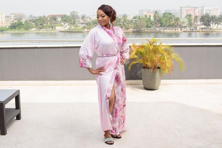 DESIGNER’S NOTE: This elegant pink kimono is crafted from pink lustrous satin paired with a printed floral pink satin that feels so smooth against your skin. We can't think of anything more luxurious to wear while you're getting ready on your wedding day. Designed to flatter your curves. Comfy chic. FIT: Slightly loose for a relaxed fit. Select your normal size ATTRIBUTES: Robe Length: 56 inches Model Stats: 5 ft 6, US 6 wearing a Medium size Color: Pink Fabric: Satin Print: Peacock design Sleev Floral Print Satin Wedding Gown, Pink Floral Print Wedding Gown, Floral Satin Wedding Gown, Feminine Wedding Robe With Kimono Sleeves, Wedding Robe With Kimono Sleeves For Spring, Spring Wedding Robe With Kimono Sleeves, Pink Silk Wedding Robe, Elegant Pink Bridesmaid Robe, Elegant Pink Kimono For Loungewear