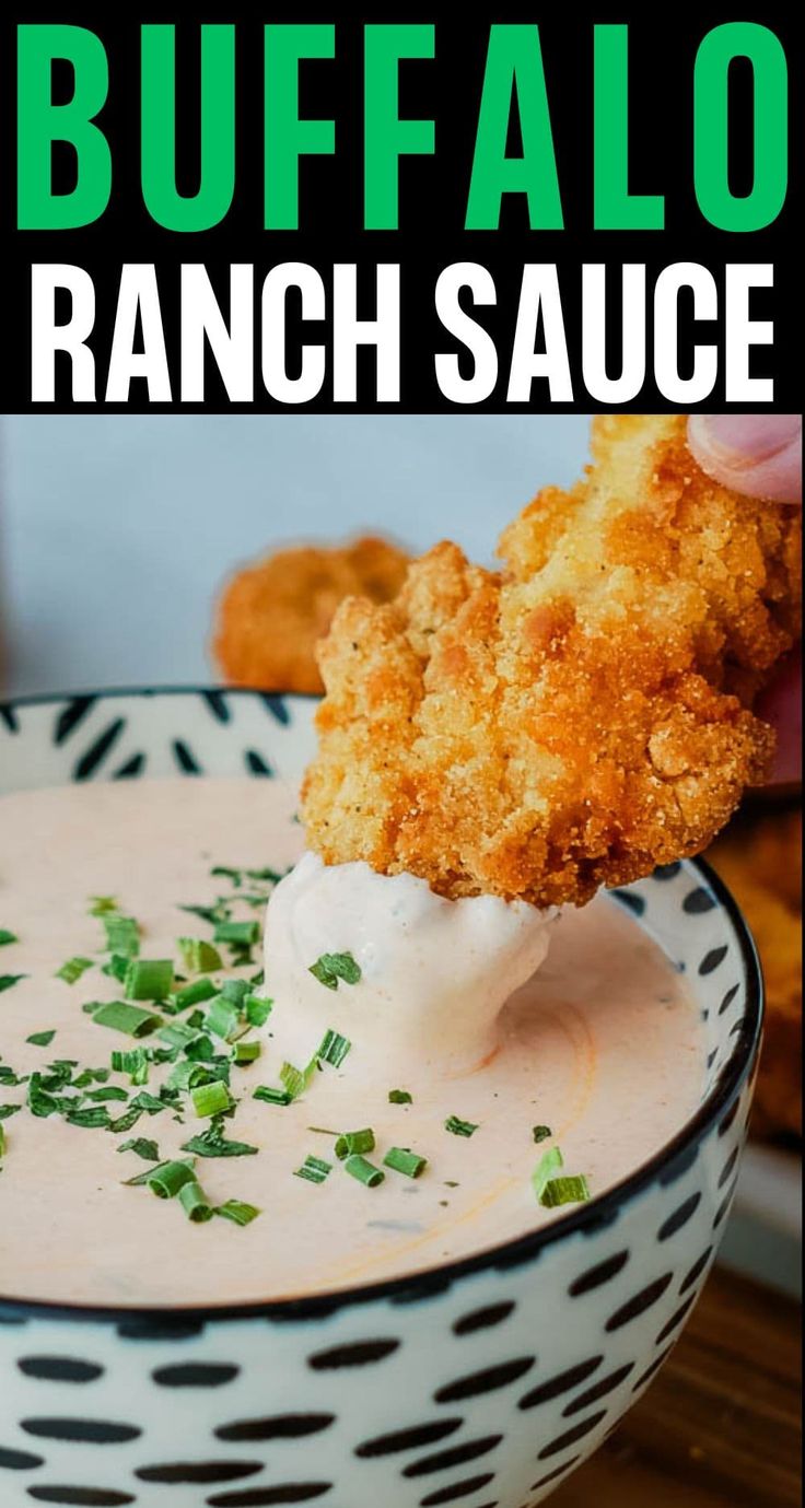 a hand dipping ranch sauce into a bowl with chicken tenders in the background and text overlay that reads buffalo ranch sauce