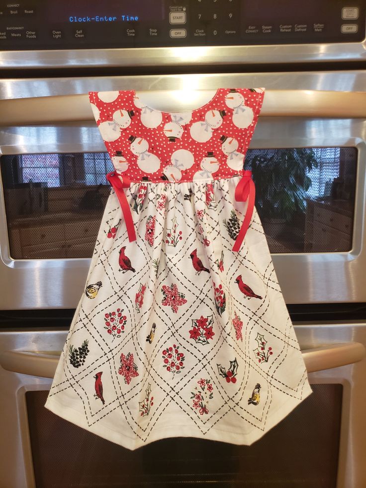 the apron is hanging on the oven door and ready to be made into a christmas dress