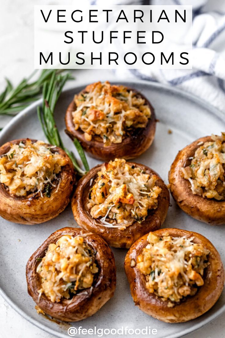 vegetarian stuffed mushrooms on a white plate with rosemary sprigs and text overlay