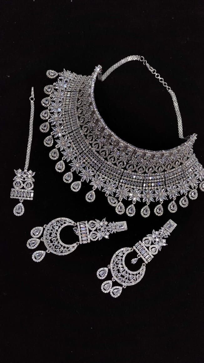 Designer elegant Cubic zirconia necklace set .  This necklace is a perfect example of High Quality handwork . > Premium quality CZ stones  were used in this necklace. Inspired By Sabyasachi Wedding jewelry . Such intricate detailing in this Inspired Heritage Royal Set with american diamond work. This set will surely make heads turn .. Wedding jewelry , wedding necklace , bridal collection , bridal necklace , engagement jewelry , bridal shower jewelry . Festive Necklace With Intricate Design In Cubic Zirconia, Festive Necklace With Intricate Cubic Zirconia Design, Festive Cubic Zirconia Necklace With Intricate Design, Traditional Silver Jewelry With Sparkling Stones, Dazzling Crystal Necklace With Stone Work, Festive Heavy Cubic Zirconia Necklaces, Dazzling Crystal Necklaces With Intricate Design, Round American Diamond Necklaces With Stone Work, Traditional Diamond Bridal Necklace With Sparkling Stones