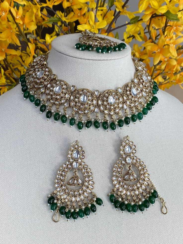 green kundan necklace Necklace With earrings x tikka  Lightweight  Style tip- ----------- Pair it with any beautiful traditional outfits  and flaunt with Unique style of collection from us. Perfect match for Festival and Traditional wear.  Take Care Tips-  ---------------- Kee away from perfume, Hair spray and. Moisture.  Store in dry place , Ziplock bag or Airtight box.    Clean with dry cloth.  Jewellery is the last thing you should wear and first thing you should remove.  -------------------- Green Kundan Necklace With Tilla For Festivals, Heavy Green Tikka For Celebration, Heavy Green Kundan Necklace For Festive Occasions, Beaded Kundan Choker Necklace, Green Kundan Necklace With Tilla, Green Chandbali Choker For Diwali, Heavy Green Kundan Necklace For Festivals, Festive Green Bridal Choker Necklace, Green Choker For Diwali Celebration