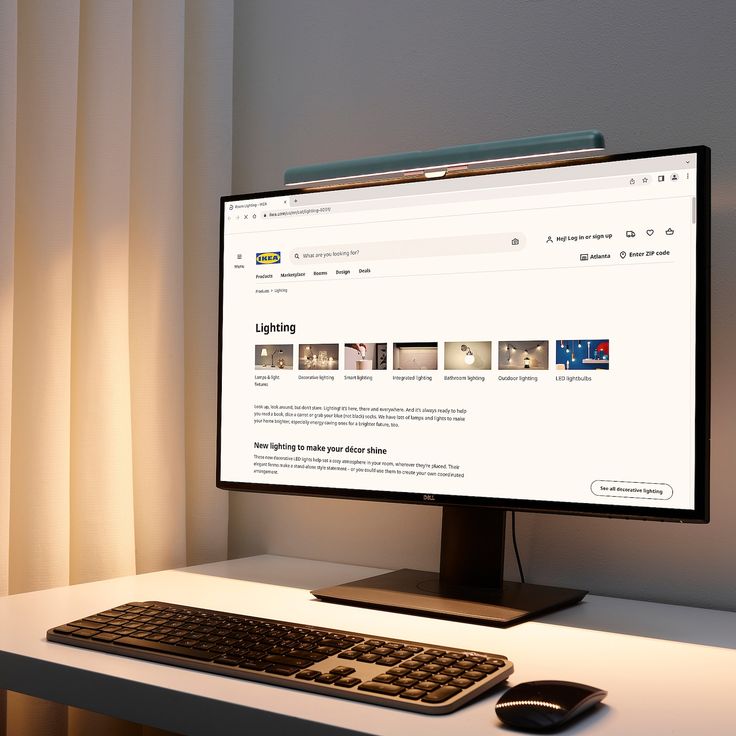 a computer monitor sitting on top of a white desk next to a keyboard and mouse