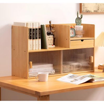 a wooden desk with books and magazines on it