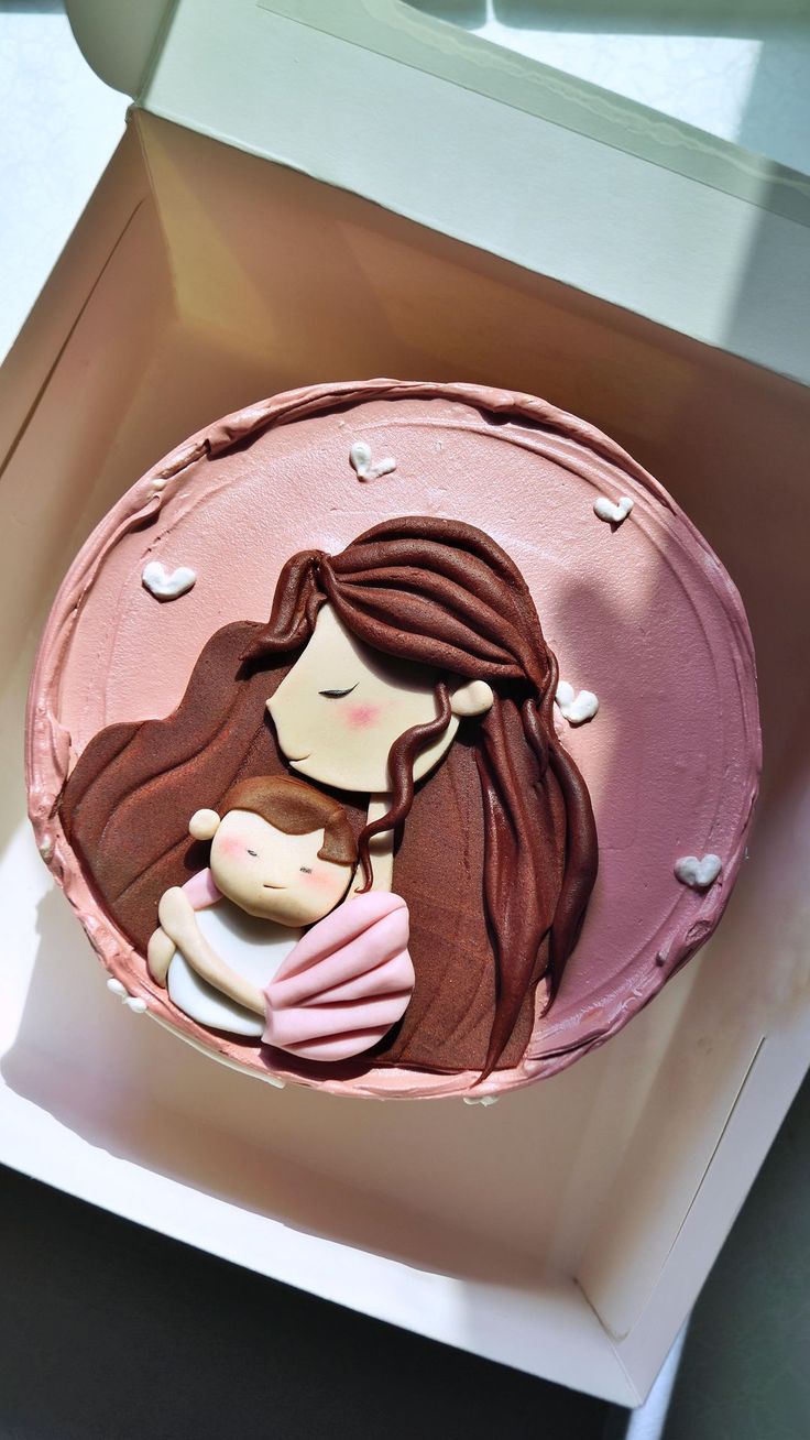 there is a pink cake with a woman holding a baby