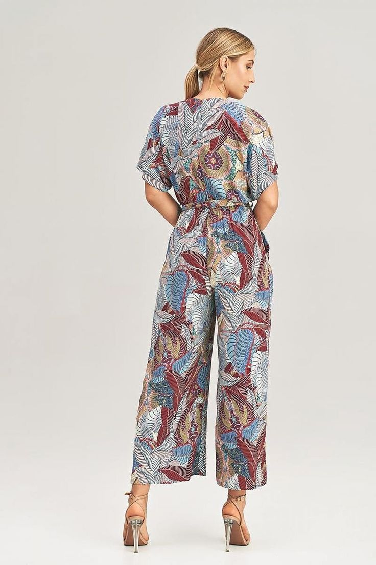 Step into the season of sunshine and sass with our Summertime Chic Kimono Jumpsuit. Designed for the fashion-forward and free-spirited, this jumpsuit combines elegance and comfort, making it the ultimate choice for warm-weather adventures. With its loose fit, wide legs, and kimono-style sleeves, this jumpsuit will have you feeling effortlessly chic and ready to conquer the summer in style. Key Features & Benefits: Breezy Elegance: The loose fit and wide 7/8 legs provide a breezy and comfortable Relaxed Fit V-neck Jumpsuits And Rompers For Vacation, Multicolor Tropical Print V-neck Jumpsuits And Rompers, Chic Rayon Jumpsuits And Rompers For Spring, Casual V-neck Jumpsuits And Rompers With Tropical Print, Beach Printed Patterned Jumpsuits And Rompers, Casual Printed Patterned Jumpsuits And Rompers, Casual Patterned Jumpsuits And Rompers For Vacation, Casual Patterned Jumpsuits And Rompers For Spring, Multicolor Short Sleeve Jumpsuits And Rompers For Summer