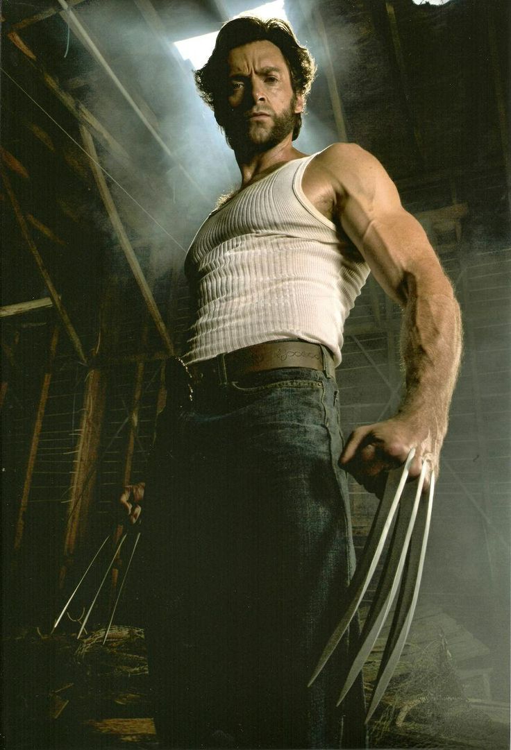 a man in white shirt and black pants holding a wolverine stick