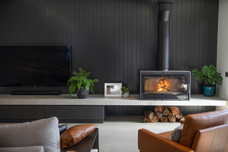 a living room filled with furniture and a fire place next to a flat screen tv