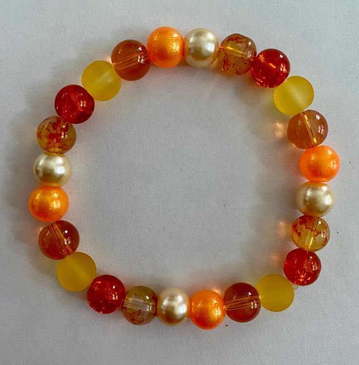 Autumn/fall colored beaded elastic bracelet. Great accessory for your fall wardrobe. Can be worn alone or stacked with other bracelets. Orange Stretch Bracelet With 8mm Beads, Orange Beaded Stretch Bracelet With Round Beads, Casual Orange Hand-strung Beaded Bracelets, Casual Orange Beaded Bracelets With Round Beads, Orange Bohemian Stretch Bracelet With Round Beads, Bohemian Orange Stretch Bracelet With Round Beads, Orange Beaded Stretch Bracelet, Adjustable Orange Stretch Bracelet With Round Beads, Casual Brown Beaded Stretch Bracelet