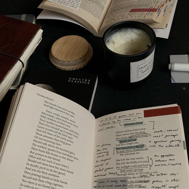 an open book sitting on top of a table next to a cup of coffee and other items