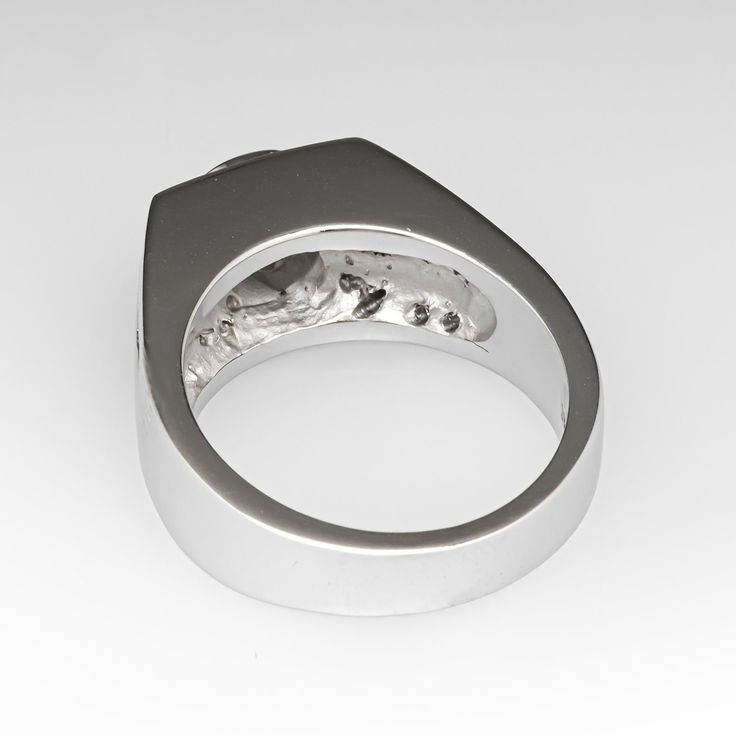 This attractive wide band diamond ring is centered with one (1) round brilliant cut diamond that is bezel seat and weighs approximately 0.30 carats. Accenting the top of the ring are eight (8) channel/ bead set round brilliant cut diamonds. Each shoulder of the ring is accented with two-rows of four (4) channel set round brilliant cut diamonds. The ring measures 7.8mm at the top, rises 6.8mm above the finger, tapering to 3.9mm wide and 1.4mm thick at the base of the shank. It is currently a size 5.25. Anniversary Diamond Ring With Bezel Setting Wide Band, Anniversary Wide Band Ring With Tension Setting, Anniversary Ring With Bezel Setting And Wide Band, Modern Wide Band Ring With Tension Setting For Anniversary, Modern Wide Band Diamond Ring With Vvs Clarity, Sapphire Diamond Ring With Tension Setting, Modern Sapphire Ring With Diamond For Anniversary, Modern Emerald Ring With Brilliant Cut For Anniversary, Modern Sapphire Diamond Ring For Anniversary