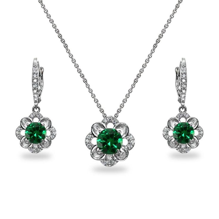 Wear this stylish jewelry set to enhance your daytime and evening look. These dangle earrings and necklace feature three 6mm solitaire round-cut stones in a polished flower design encrusted with cubic zirconia stones. This luxurious set is crafted of fine sterling silver. The pendant hangs from an 18 inch rolo chain and secures by a spring-ring clasp. These dainty earrings measure 11.5mm W and 28.5mm L . This dainty necklace measures 11.5mm W and 11.5mm L. This fashion set in fine jewelry is a g Flower Shaped May Birthstone Jewelry, Elegant Green Flower Shaped Jewelry, Elegant Green Flower-shaped Jewelry, Classic Cubic Zirconia Jewelry In Flower Shape, Elegant May Birthstone Necklace In Flower Shape, Elegant Flower Shaped Necklace With May Birthstone, Elegant May Birthstone Necklace With Flower Shape, Elegant Flower-shaped Necklace With May Birthstone, Elegant Flower Jewelry For May Birthstone