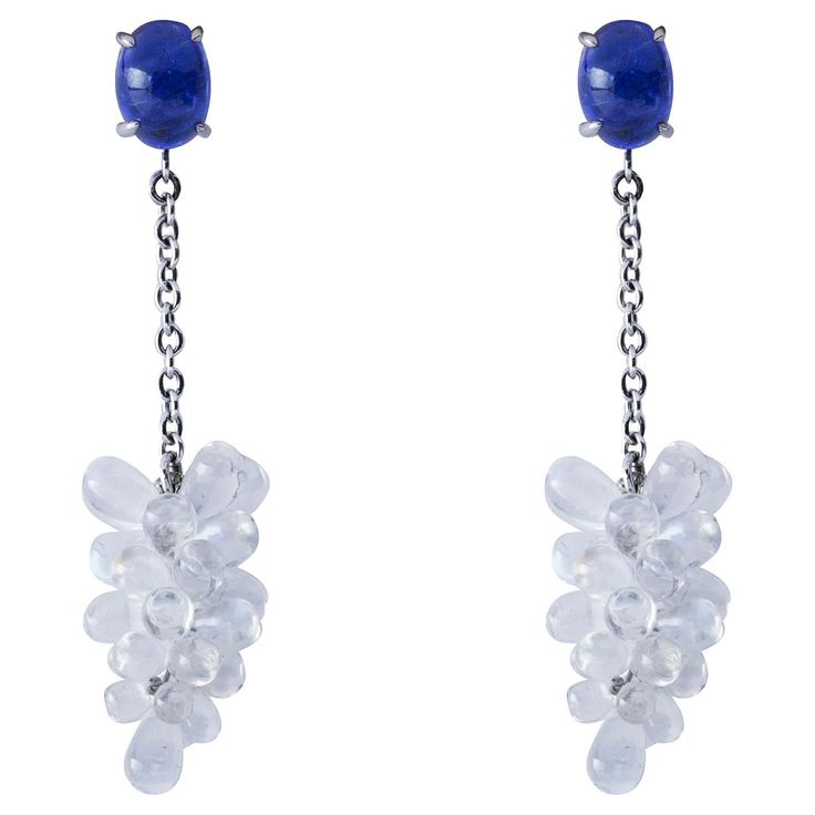 Alex Jona design collection, hand crafted in Italy, beautiful Clusters of natural cabochon Moonstone drops weighing 22 carats, dangling from two oval cabochon Tanzanites weighing 3.59 carats in total, mounted in 18k white gold. Length 1.7in.-43mm, Width 0.39in.-10mm. Posts with friction backs for pierced ears. Alex Jona jewels stand out, not only for their special design and for the excellent quality of the gemstones, but also for the careful attention given to details during all the manufacturi