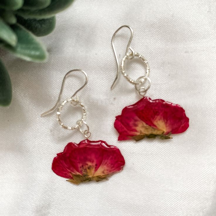 These stunning real flower earrings are handmade by myself with love and dedication. Every flower is carefully preserved in resin.  They make a perfect and special gift for a loved one, or for your wonderful self because we all deserve to feel beautiful. Free shipping worldwide! Purchase more than one pair for a free upgrade to express shipping!  -Each delicate flower is coated by hand with no moulds used, and the flowers are sourced locally and ethically.  -The flowers are all unique, as nature Adjustable Pressed Flowers Earrings As Gift, Flower Shaped Earrings With Rose Design For Gift, Flower Rose Design Earrings As Gift, Rose Design Flower Earrings As Gift, Flower Shaped Rose Design Earrings For Gifts, Nickel Free Botanical Earrings As Gift, Dangle Flower Earrings With Natural Inclusions As Gift, Nickel Free Botanical Earrings For Gifts, Dangle Earrings With Natural Inclusions For Gift