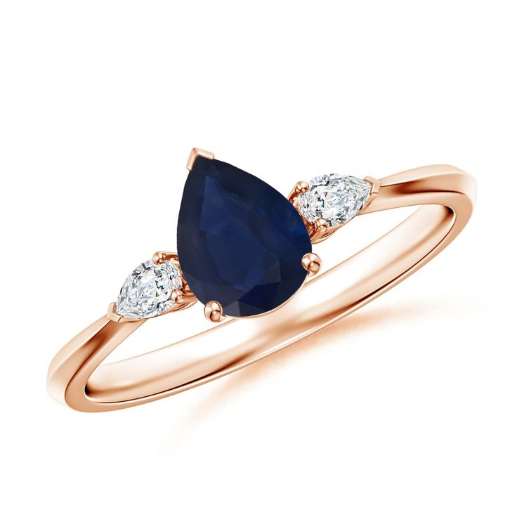 a rose gold ring with a pear shaped blue sapphire and three white diamonds on the side