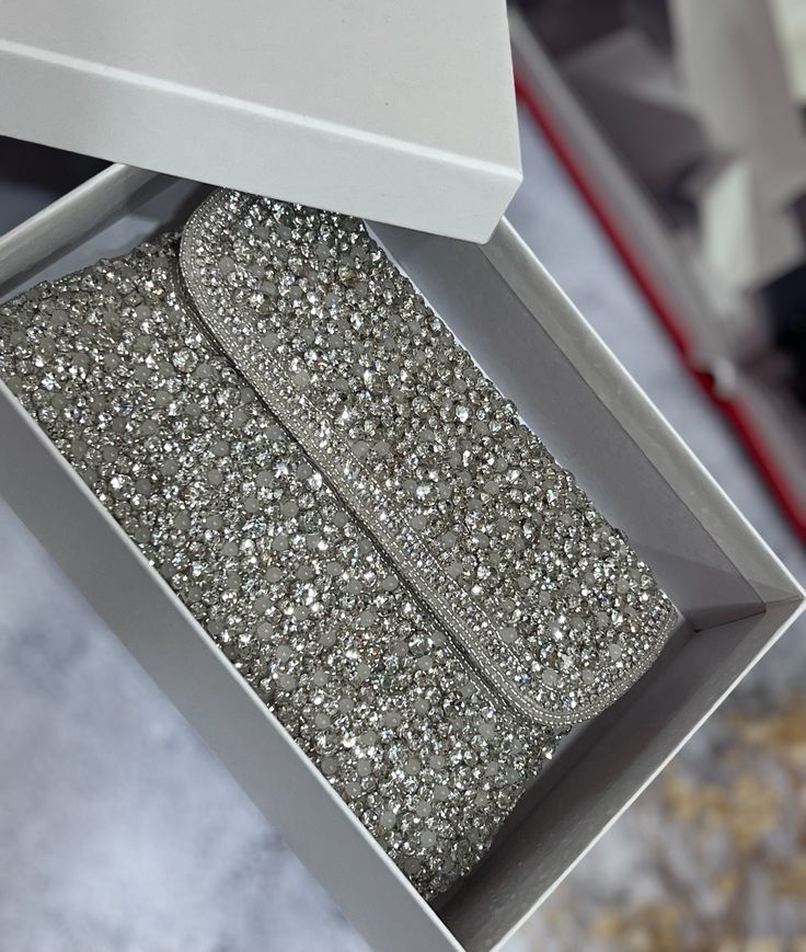 Introducing our exquisite Handmade Evening Clutch, a dazzling accessory fit for a bride's special day! 🌟 Handcrafted Elegance: Each clutch is meticulously handmade by skilled artisans, ensuring the utmost attention to detail and quality. ✨ Sparkling Crystals: Adorned with silver stones  that catch the light with every movement, this clutch adds a touch of glamour to your bridal ensemble. 👛 Perfect Size: With a roomy interior to hold your essentials - from keys, makeup to your phone - it strikes the perfect balance between style and functionality. 🌸 Bridal Elegance: The timeless design and neutral color palette make it the ideal complement to any bridal gown, whether classic or contemporary. 💕 Thoughtful Gift: Looking for a special gift for your bridesmaids or loved ones? This clutch is Silver Embellished Bridal Accessories, Silver Rhinestone Bridal Accessories For Evening, Silver Bedazzled Bridal Accessories For Party, Silver Crystal Bridal Accessories For Evening, Silver Embellished Bridal Accessories For Evening, Silver Beaded Bridal Accessories For Party, Elegant Bedazzled Bridal Accessories For Party, Glamorous Silver Bridal Accessories For Evening, Elegant Bedazzled Silver Bridal Accessories