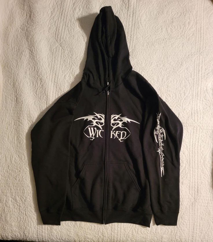 a black zip up hoodie with white writing on it