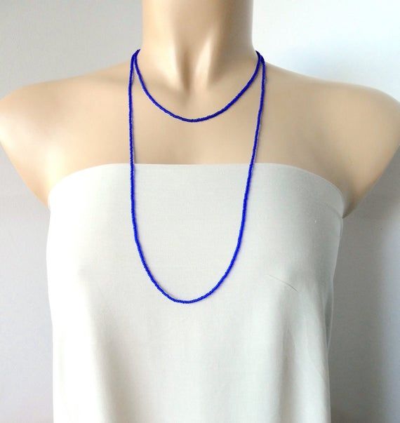 This is a one strand beaded sapphire blue necklace, with NO CLASP, and can be worn in multiple ways, as shown in pictures. ❤ SIZESThis item is one size fits all.❤ PROCESSING AND SHIPPINGMost orders are made and shipped out in one business day. Please check delivery timeframes for your location on the description below.  ❤ CUSTOM ORDERSIf you like this item in a different color, send me a message indicating: color, size and quantity needed. I will send you a link for a "custom order" and you'll b Blue Beaded Multi-strand Layered Necklace, Blue Multi-strand Beaded Layered Necklace, Blue Layered Necklace With Round Beads As A Gift, Blue Round Beads Layered Necklace For Gift, Blue Layered Necklace With Round Beads For Gift, Blue Single Strand Long Beaded Necklace, Blue Long Single Strand Beaded Necklace, Handmade Blue Lariat Long Necklace, Minimalist Blue Beaded Chain Necklaces