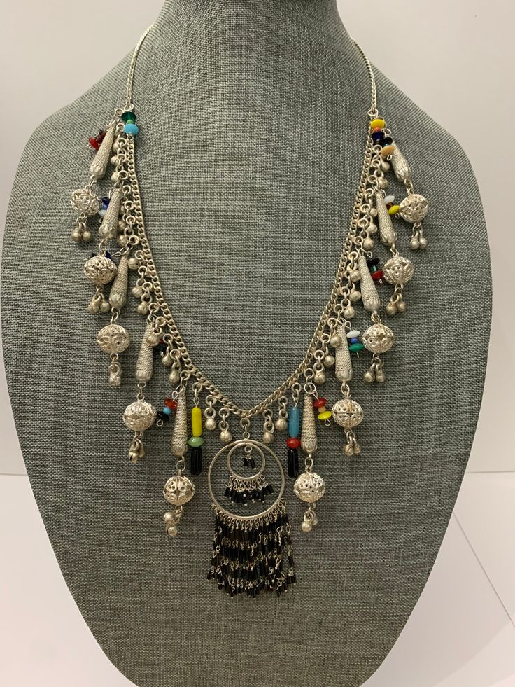 vintage funky handmade bohemian chic silver plate necklace. I have recyceld this beautiful old siver plate necklace that was made in the 1960's giving it a great bohemian chic look and a slight splash of color. The necklace is metal and silver plate and the beads are hand made glass. the necklace measures about 24 inches and is quite large with all its adonrnments. please note most of the vintage jewelry in the is section has been rescued recycled or repaired. which means they may have small alt Bohemian Multicolor Nickel-free Beaded Necklaces, Nickel Free Multicolor Bohemian Beaded Necklaces, Nickel Free Multicolor Beaded Necklace For Festivals, Silver Metal Beaded Necklace With Dangling Beads, Nickel-free Multicolor Beaded Necklace For Festival, Handmade Sterling Silver Beaded Necklaces For Festivals, Silver Beaded Necklace With Large Metal Beads, Handmade Sterling Silver Beaded Necklace For Festivals, Silver Beaded Necklace With Dangling Metal Beads