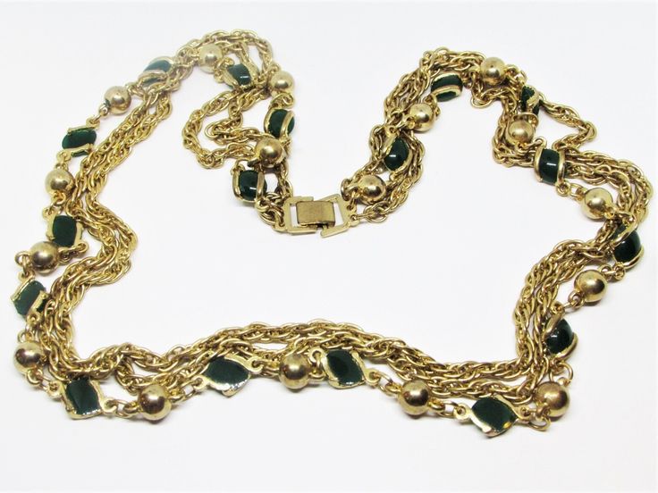 "A classic vintage 1960's gold multi-strand necklace with layered chains. This lovely gold plated necklace has three strands featuring chunky twisted rope chains, golden ball beads and unique flat green glass oval crystals in open bezel settings. A striking necklace that would be perfect for everyday as well as special occasions. -Age: 1960's -Material(s): Glass crystals and gold plated metal -Size: 25\" long -Brand / Hallmarks: Unsigned -Condition: In fabulous wearable condition! No noticeable Double Strand Costume Jewelry Chain, Vintage Double Chain Necklace For Party, Vintage Multi-strand Jewelry For Formal Occasions, Vintage Double Strand Chain Jewelry, Vintage Style Long Necklace With Double Chain, Vintage Double Strand Gold Layered Necklace, Vintage Double Strand Chain Necklace, Vintage Double Strand Gold Jewelry, Vintage Double Strand Chain Necklaces