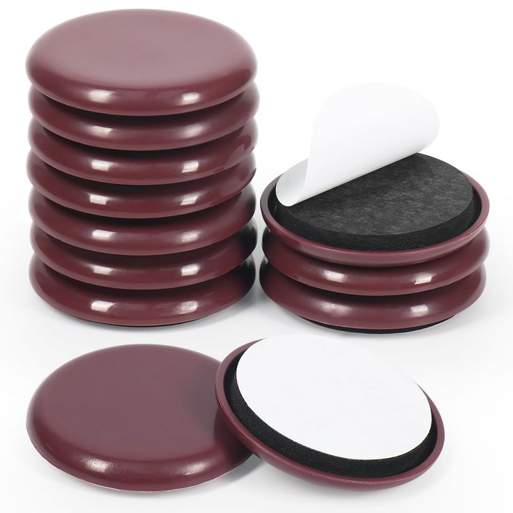 a stack of maroon and white round coasters