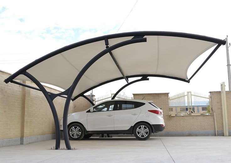 a white car is parked under an awning