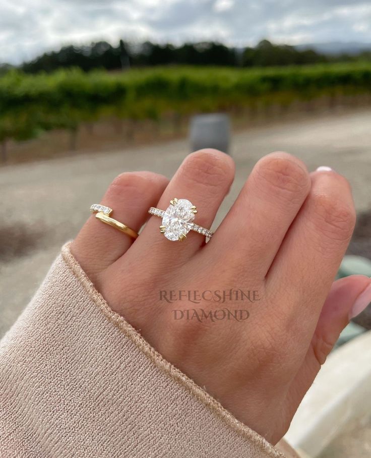 a woman's hand with a diamond ring on it