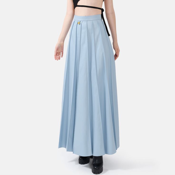 Step into effortless elegance with the Solace Vegan Leather Pleated Maxi Skirt in powder blue. With a hidden zip closure and stylish golden embellishments, this skirt combines sophistication with a touch of luxury. The lightweight fabric drapes beautifully, offering a relaxed yet structured fit with just the right amount of stretch for comfort and durability. The vertical hand-pleating creates a flattering silhouette by elongating the lower body. Perfect for stylish occasions where comfort is ke High Waist Light Blue Skirt, Light Blue High Waist Lined Skirt, High Waist Light Blue Lined Skirt, Light Blue Skirt For Workwear, Light Blue Skirt For Work, Light Blue Long Lined Skirt, Chic Light Blue Relaxed Skirt, Elegant Light Blue Lined Skirt Bottoms, Blue Formal Maxi Skirt For Spring