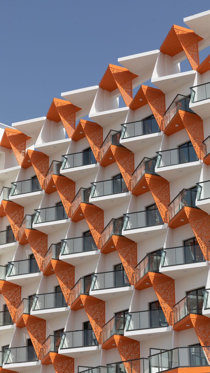 an orange and white building with many balconies